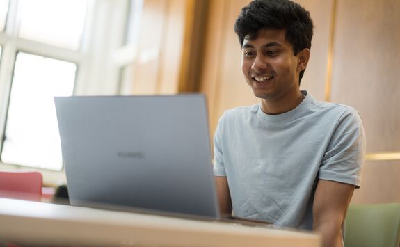 A person using a laptop at a desk